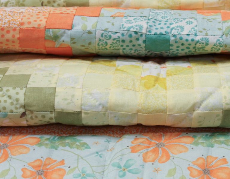 scrap quilts in many colors from family farm fabrics